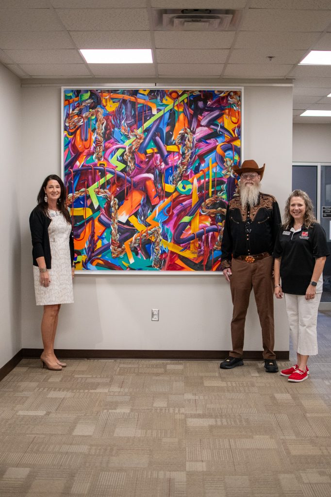 Four new pieces of art created by Yatika Starr Fields have added to the NOC Pickens Learning Commons at NOC Tonkawa.   The pieces were commissioned by Hugh Pickens.  Pictured (L-R):  Sheri Snyder, NOC Vice President for Development and Community Relations, Hugh Pickens, NOC President Diana Morris.