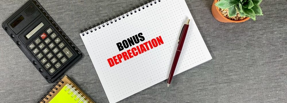bonnus depreciation written on notepad with calculator